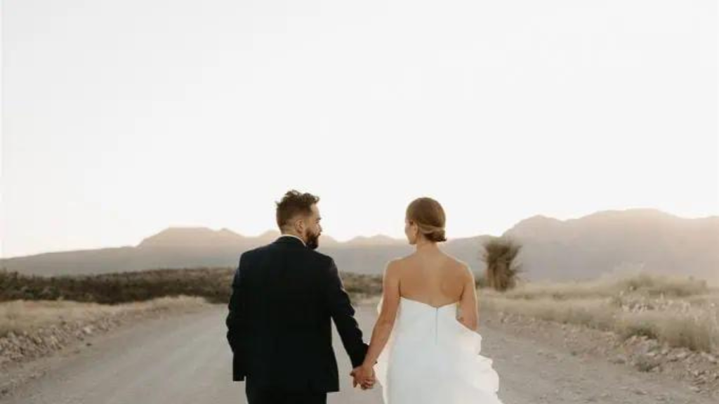 bride and groom dirt road mountain view