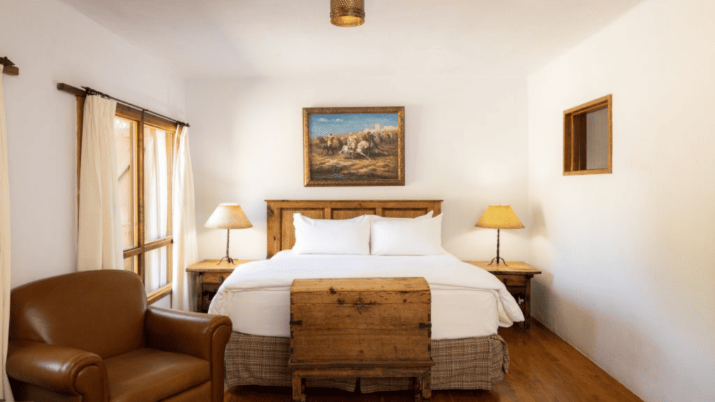 Acequia King room with antique chest and mountain painting