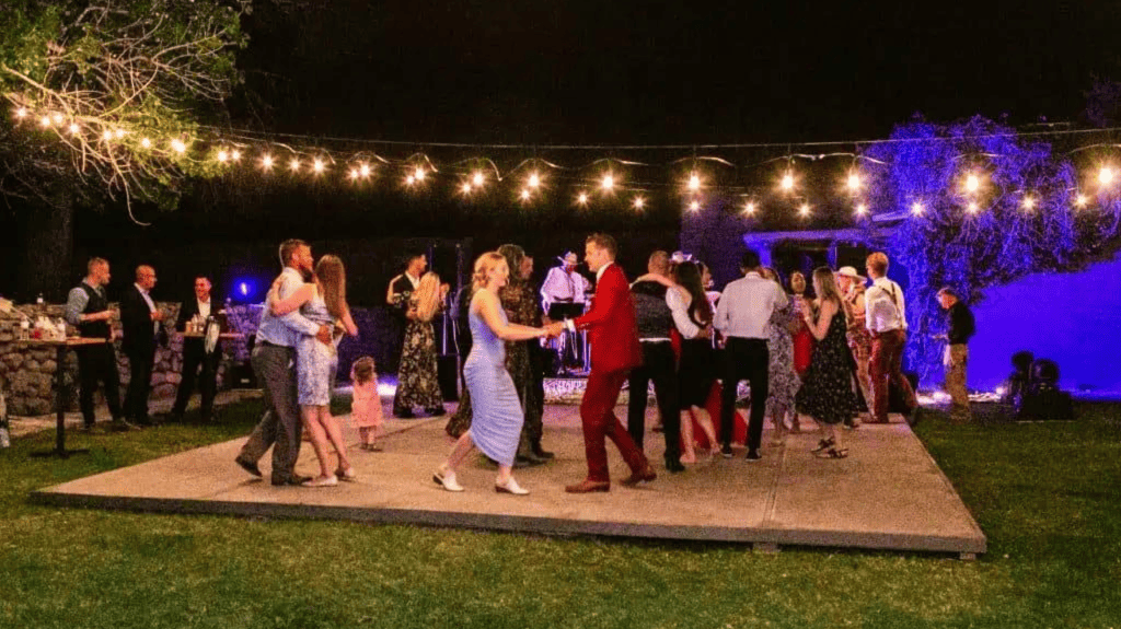 reception dance floor with string lights and band