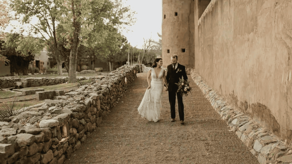 Bride and groom Cibolo fort walkway and rockwall