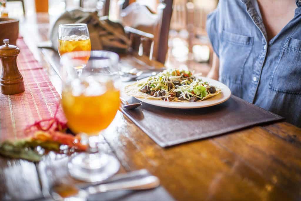 In-House guest enjoying a meal with drinks at Cibolo Creek Ranch.